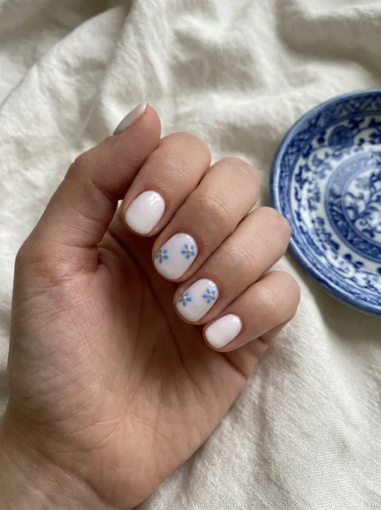 Porcelain White with Tiny Blue Flowers nail design